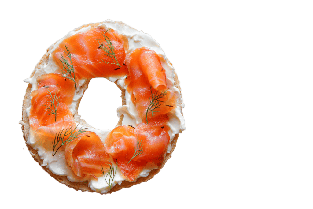 A bagel topped with cream cheese, thin slices of smoked salmon, and garnished with sprigs of dill is a delightfully classic option offered by our catering company in Long Island, NY.
