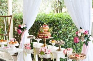 Elegant floral dessert table set outdoors in a lush Long Island garden wedding, featuring Brendel’s Bagels beautifully arranged with gourmet pastries, fresh flowers, and decorative accents.