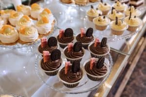 Elegant dessert table at a Long Island wedding banquet featuring Brendel’s Bagels’ delicious cupcakes, custom cakes, and a colorful candy bar display, beautifully arranged to celebrate the occasion.